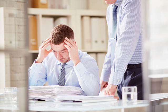 Man stressed at files at work - Whistleblower Protection